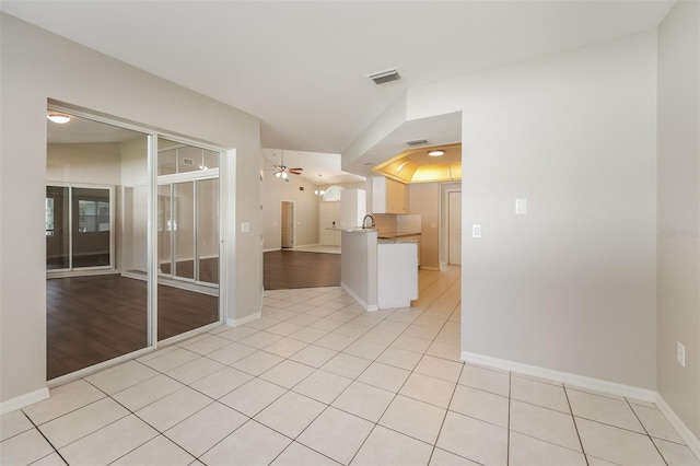 unfurnished room with ceiling fan and light tile patterned flooring