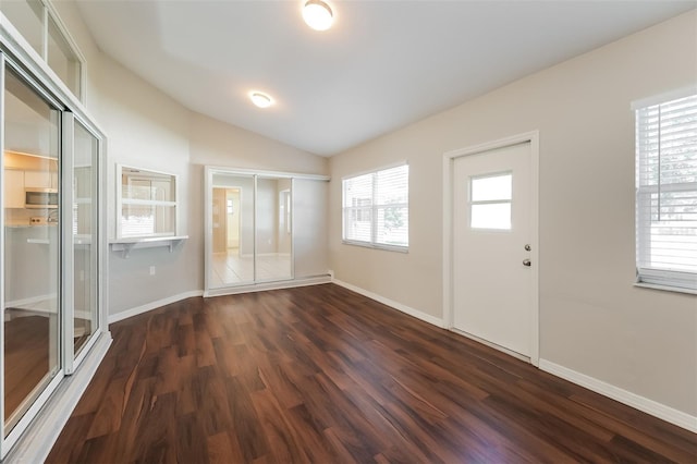 foyer featuring dark hardwood / wood-style floors and lofted ceiling