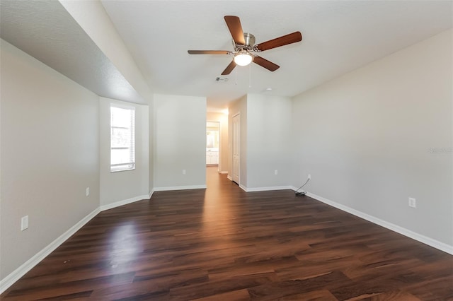 spare room with ceiling fan and dark wood-type flooring