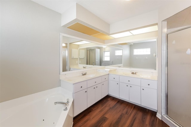 bathroom featuring hardwood / wood-style flooring, vanity, and separate shower and tub