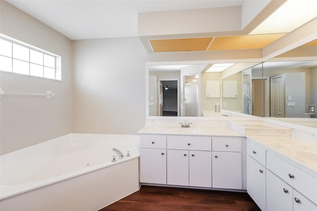 bathroom with vanity, hardwood / wood-style flooring, and shower with separate bathtub