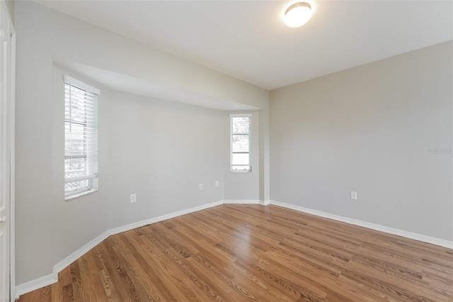 empty room with hardwood / wood-style floors