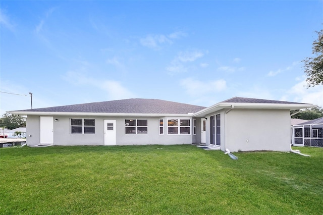 rear view of house with a lawn