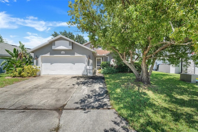 view of front of home with a garage and a front lawn