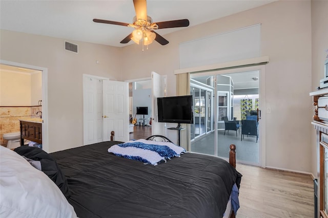 bedroom featuring access to outside, light hardwood / wood-style flooring, ensuite bathroom, and ceiling fan