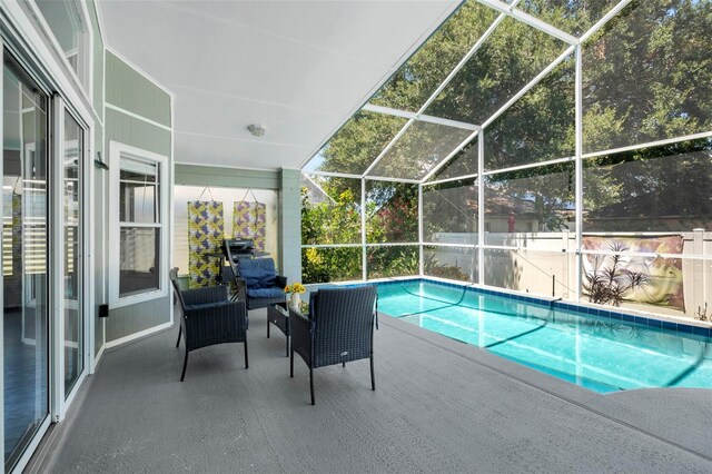 view of pool with a patio area and a lanai