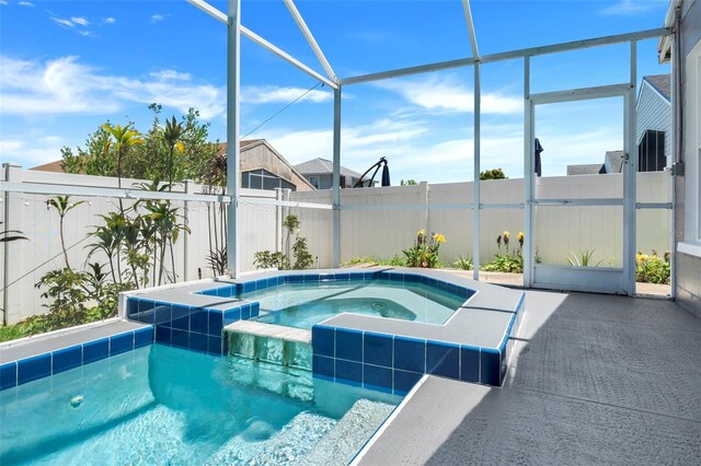 view of pool featuring a patio and an in ground hot tub