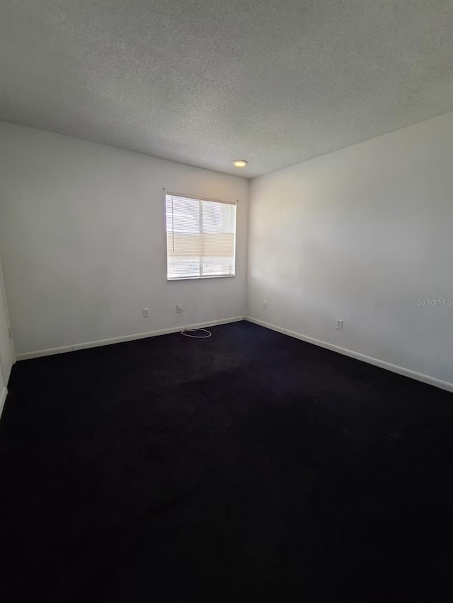 spare room with a textured ceiling