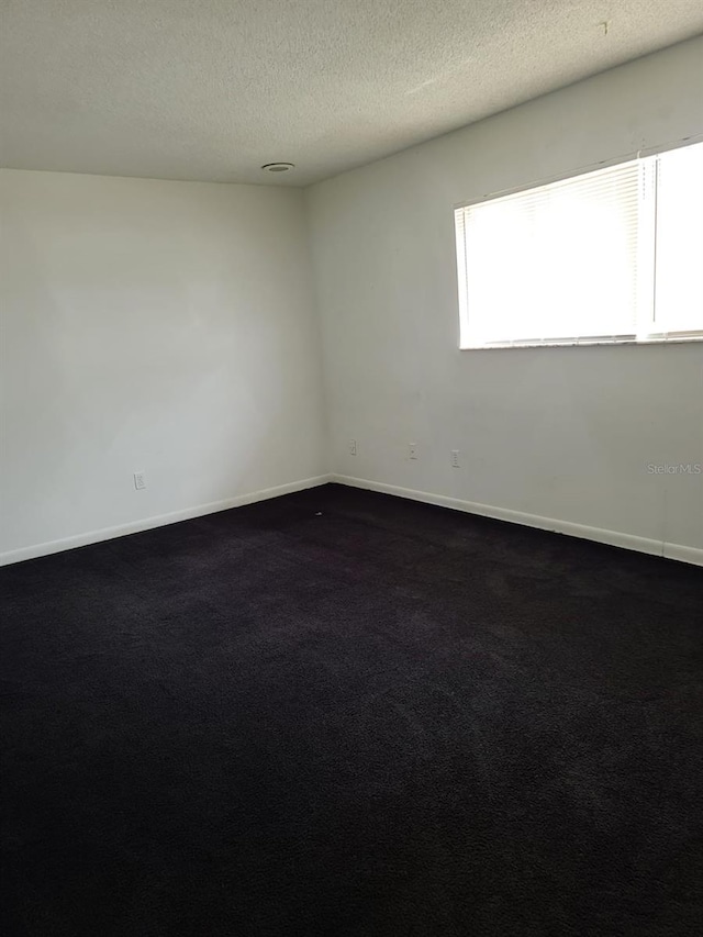 empty room featuring a textured ceiling