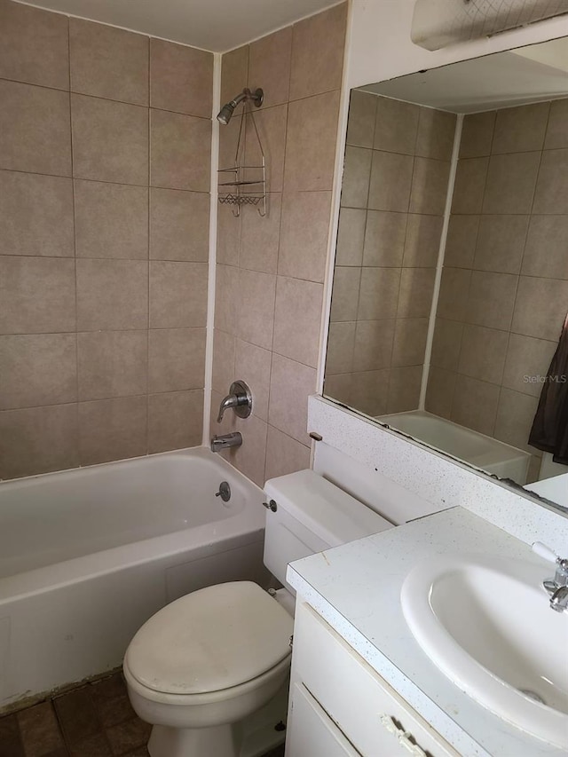 full bathroom featuring vanity, toilet, and tiled shower / bath