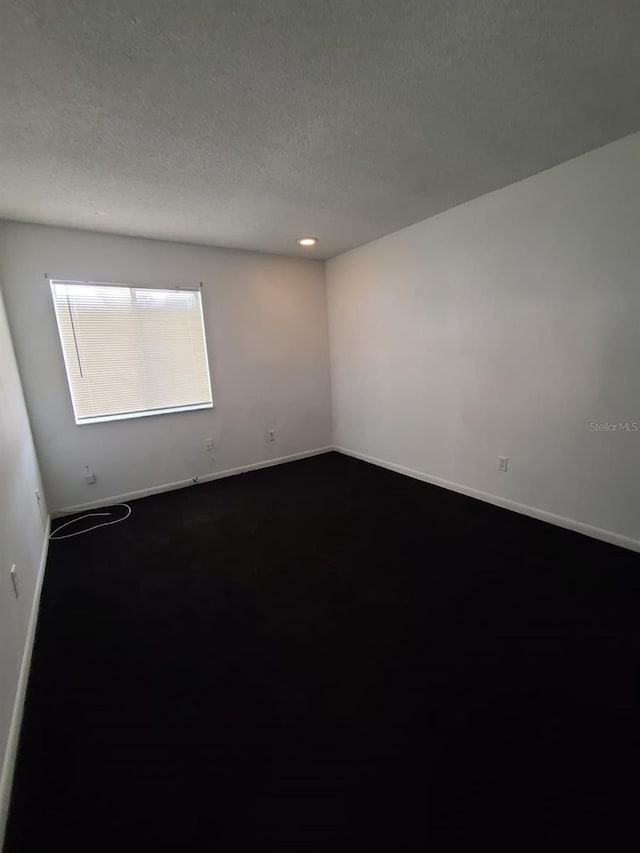 spare room featuring a textured ceiling