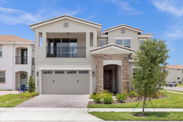 mediterranean / spanish-style home with a garage and a balcony