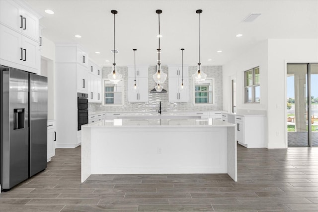 kitchen with stainless steel refrigerator with ice dispenser, white cabinetry, a kitchen island, and pendant lighting