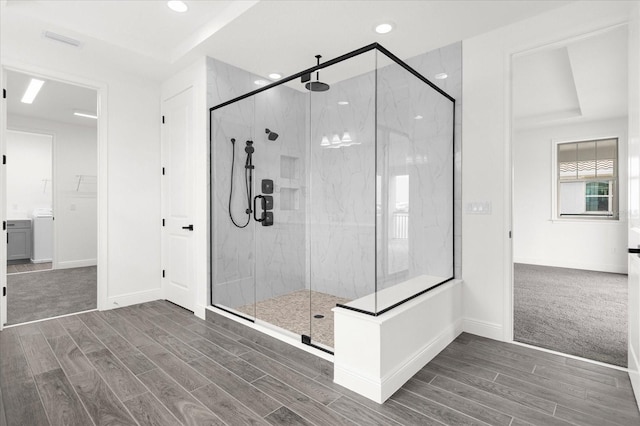 bathroom featuring a shower with shower door