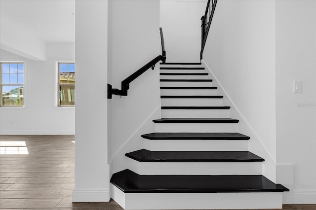 stairway with hardwood / wood-style floors