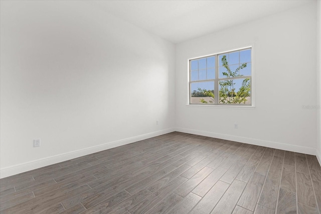 spare room with dark hardwood / wood-style floors