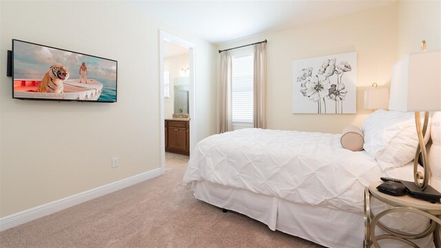 carpeted bedroom featuring ensuite bathroom