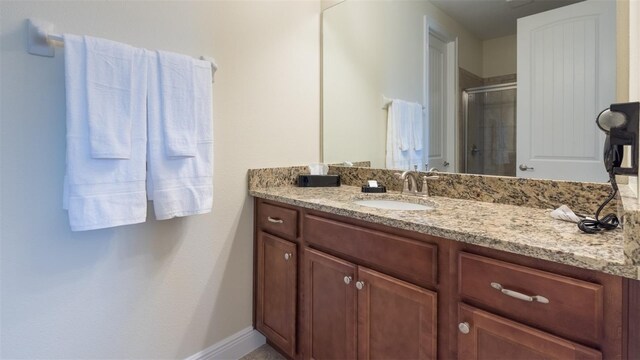 bathroom with vanity and walk in shower