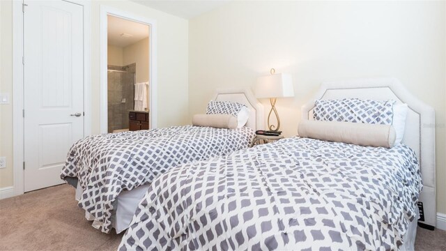 carpeted bedroom featuring ensuite bath