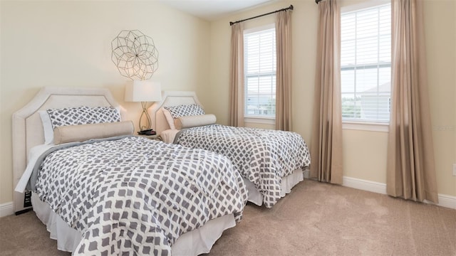 carpeted bedroom with multiple windows