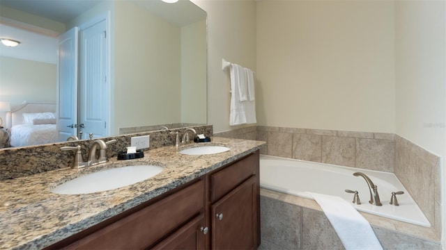 bathroom with tiled bath and dual vanity