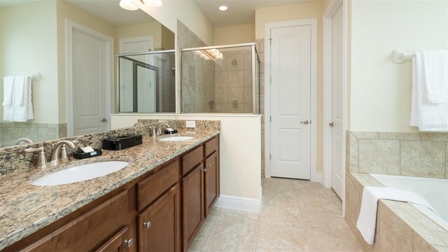 bathroom with shower with separate bathtub, double sink vanity, and tile patterned flooring