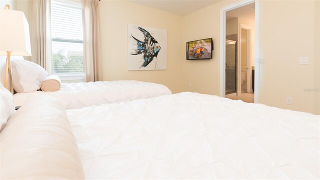 bedroom featuring light colored carpet