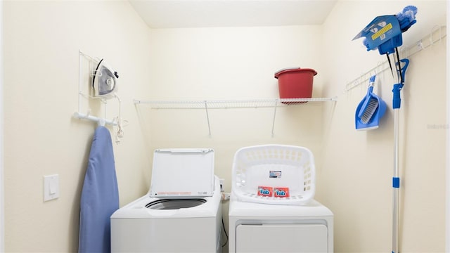 clothes washing area featuring washing machine and clothes dryer