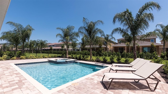 view of swimming pool with an in ground hot tub and a patio area