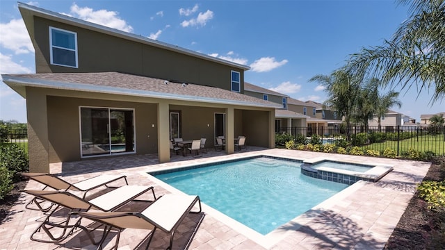 view of swimming pool featuring a patio area and an in ground hot tub