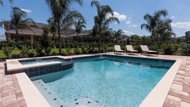 view of swimming pool featuring an in ground hot tub