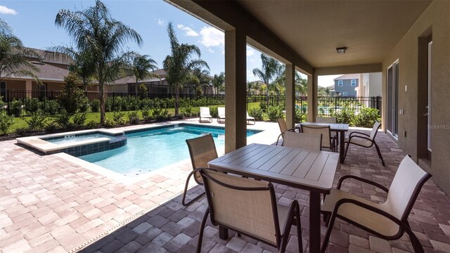 view of pool with an in ground hot tub and a patio area