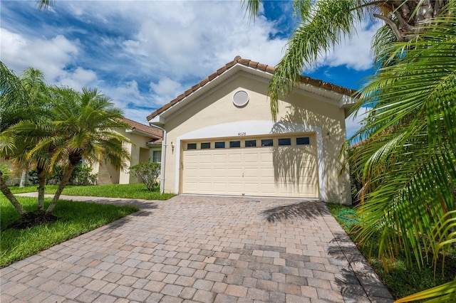 mediterranean / spanish-style home with a garage