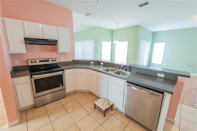 kitchen with white cabinetry, sink, light tile patterned floors, and stainless steel appliances