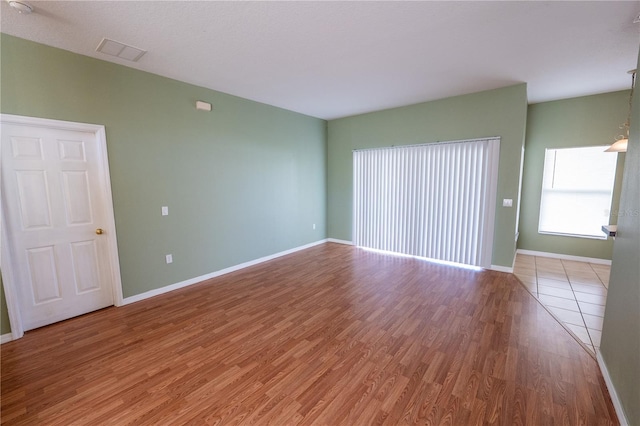 unfurnished room with hardwood / wood-style flooring