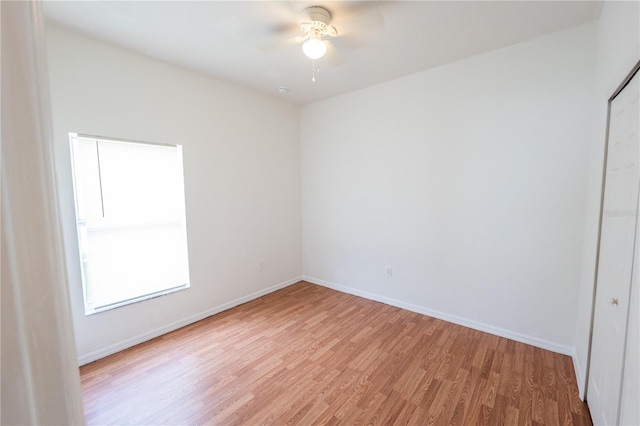 unfurnished room with ceiling fan and light wood-type flooring