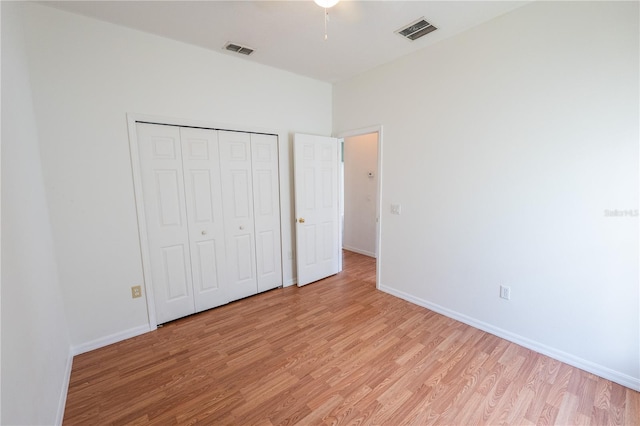 unfurnished bedroom featuring a closet and light hardwood / wood-style flooring