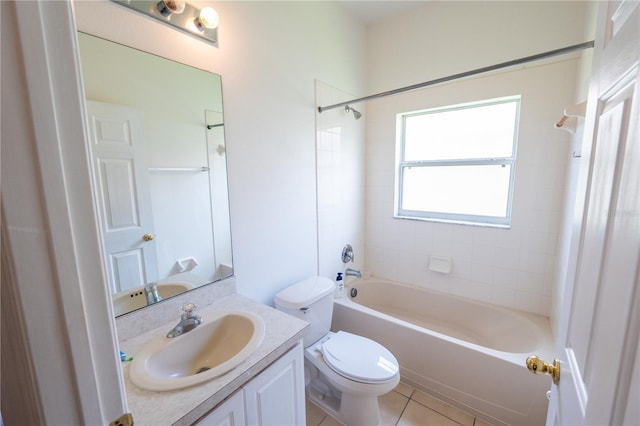 full bathroom featuring tile patterned floors, toilet, vanity, and tiled shower / bath