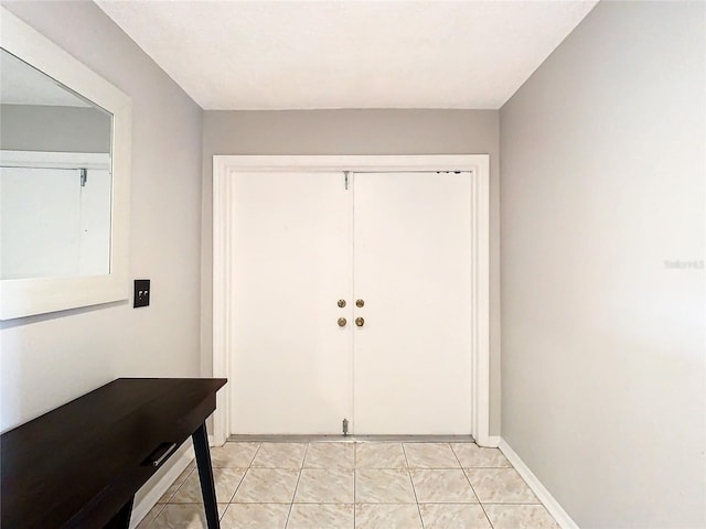 entryway with light tile patterned flooring