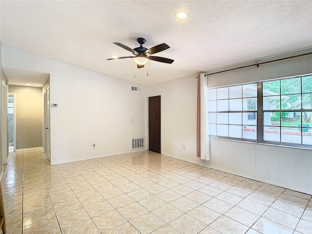 unfurnished room featuring ceiling fan and a textured ceiling