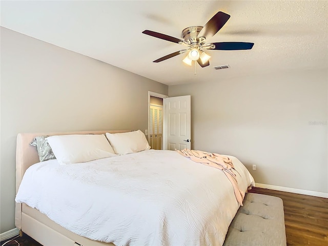 bedroom featuring ceiling fan and dark hardwood / wood-style flooring