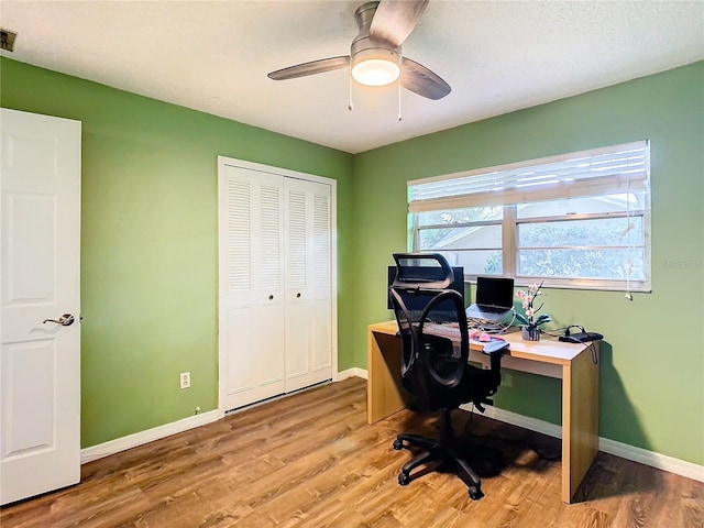 office with ceiling fan and light wood-type flooring