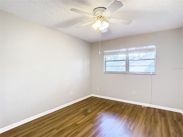 empty room featuring a textured ceiling, dark hardwood / wood-style flooring, and ceiling fan