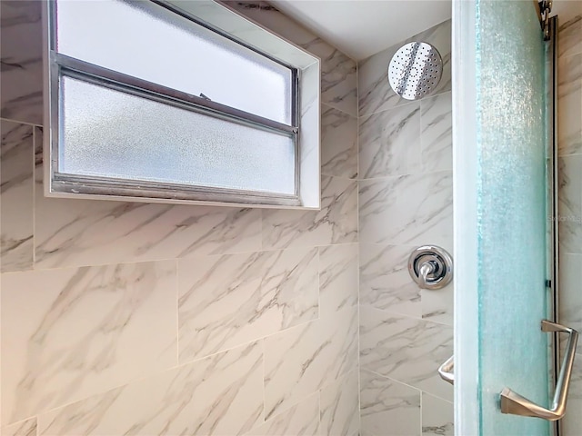 bathroom with a tile shower