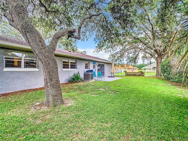 view of yard with a patio and central AC