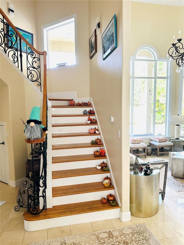 stairway with tile patterned floors and baseboards