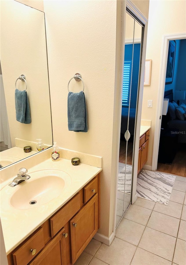 ensuite bathroom featuring vanity, ensuite bathroom, and tile patterned flooring