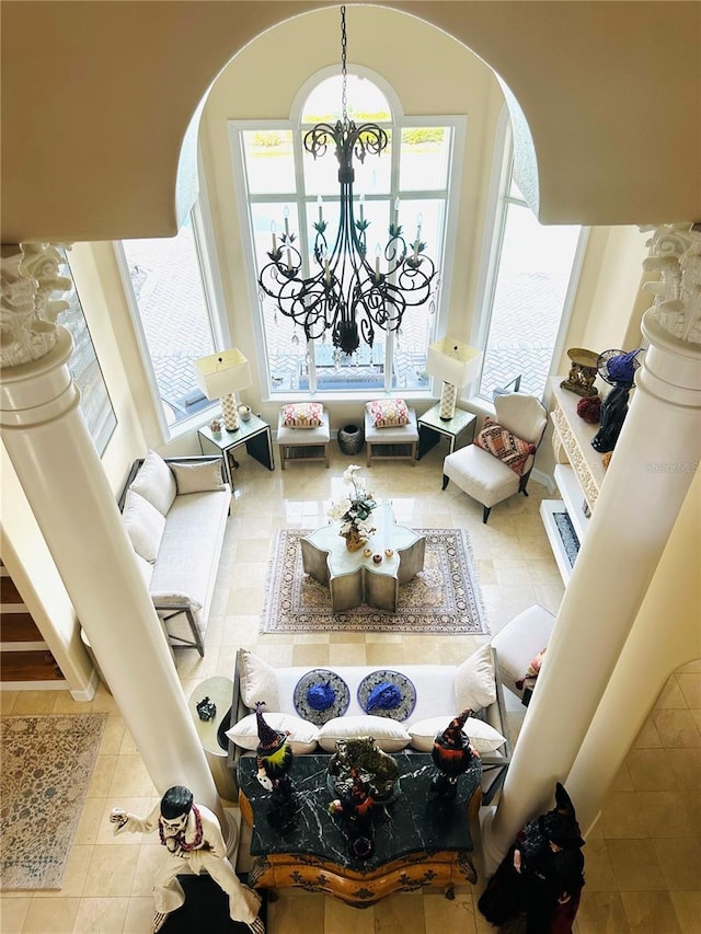 unfurnished living room featuring arched walkways, a notable chandelier, and tile patterned floors