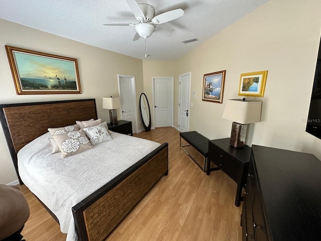 8734 Crestgate Cir, Orlando, FL 32819 - bedroom with light wood-style flooring, a ceiling fan, and baseboards