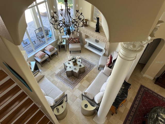 8734 Crestgate Cir, Orlando, FL 32819 - living room with arched walkways and a chandelier
